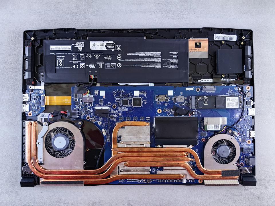Opened laptop showing the motherboard, cooling fans and battery