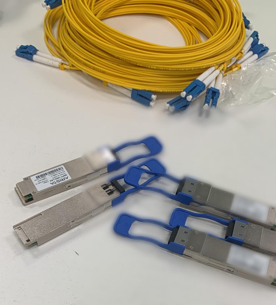 QSFP transceivers and yellow single-mode fibre patch leads ready for install